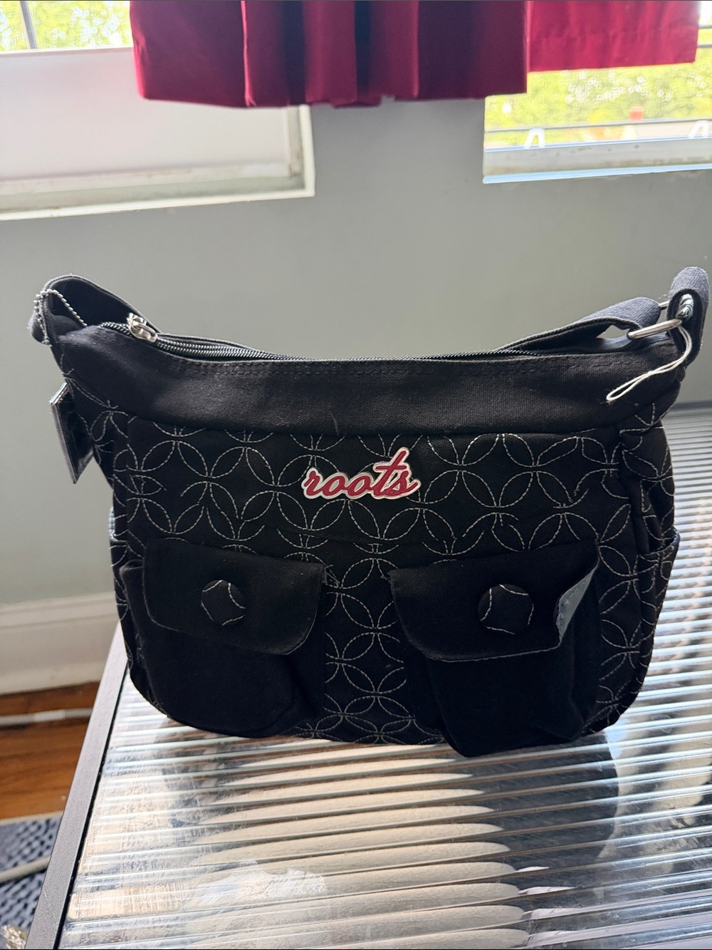 Roots Black Shoulder Bag with White Stitching and Red Logo
